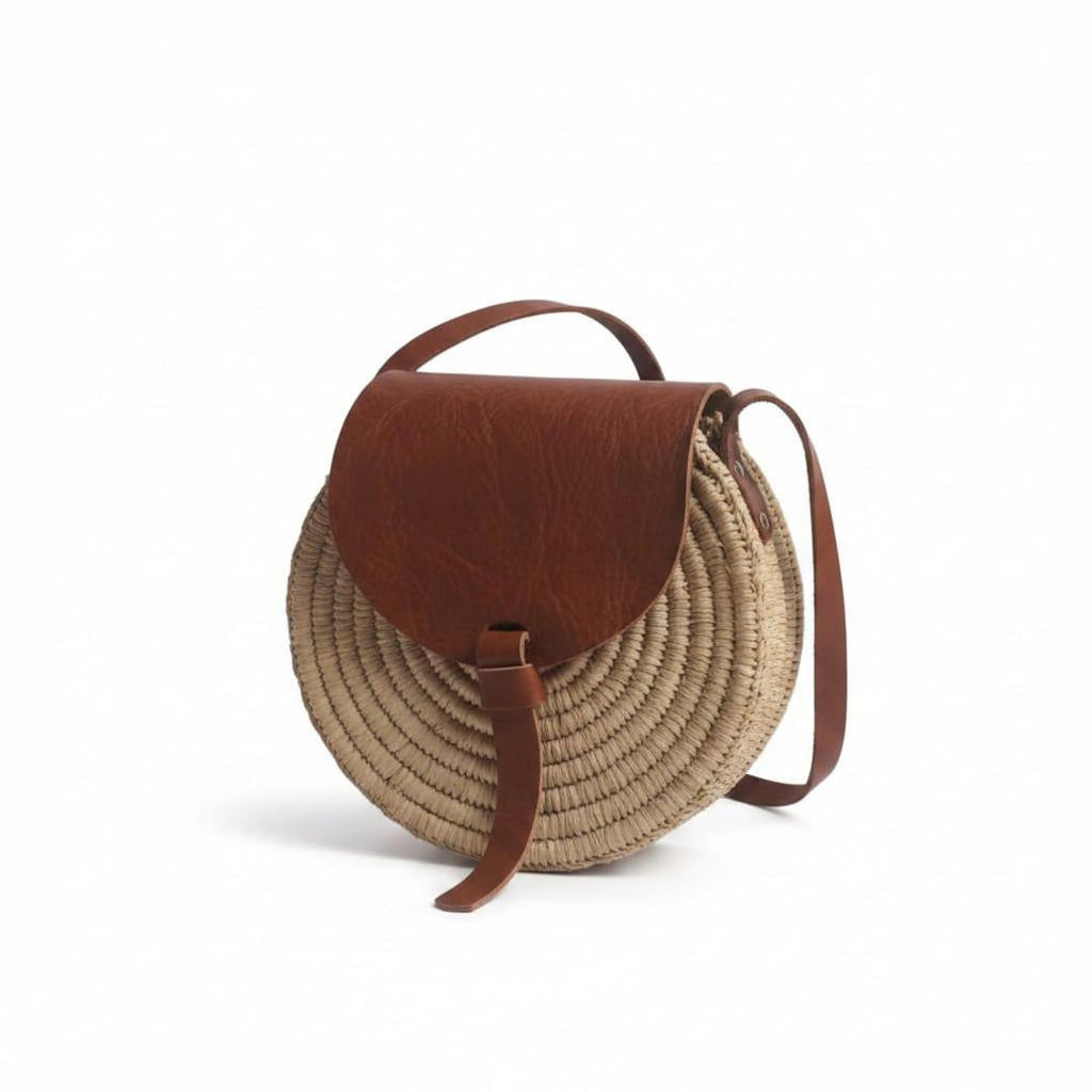 Round straw shoulder bag with leather flap and crossbody strap - handmade in Morocco