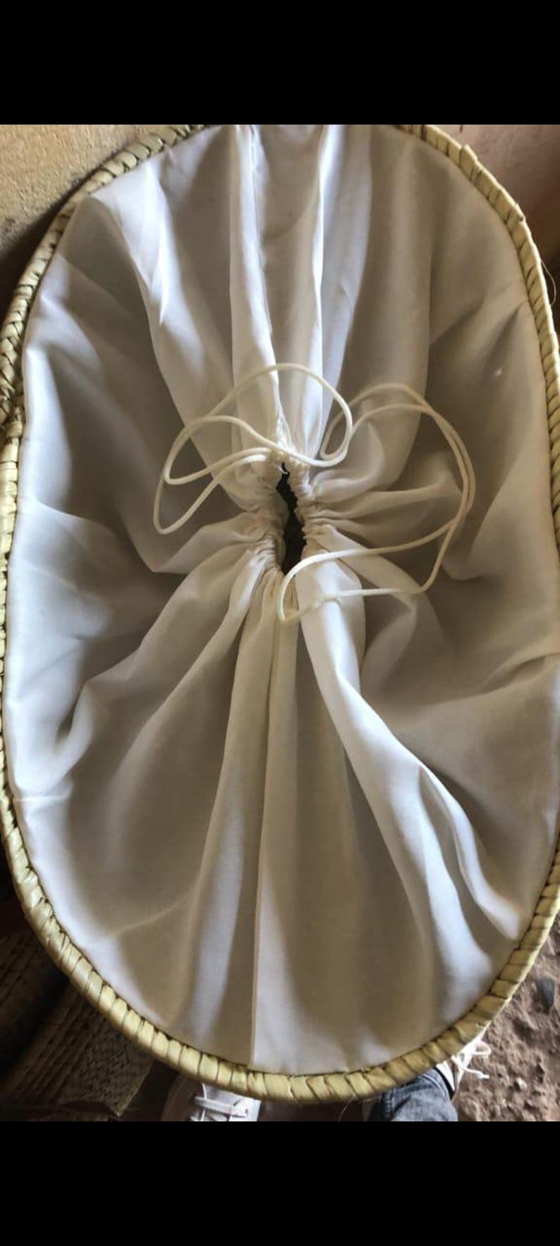 Interior of Hello Summer straw bag showing white fabric lining with drawstring