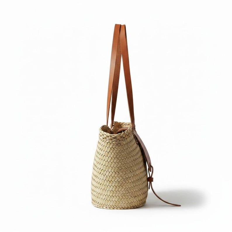 Woven straw basket bag with leather handle details