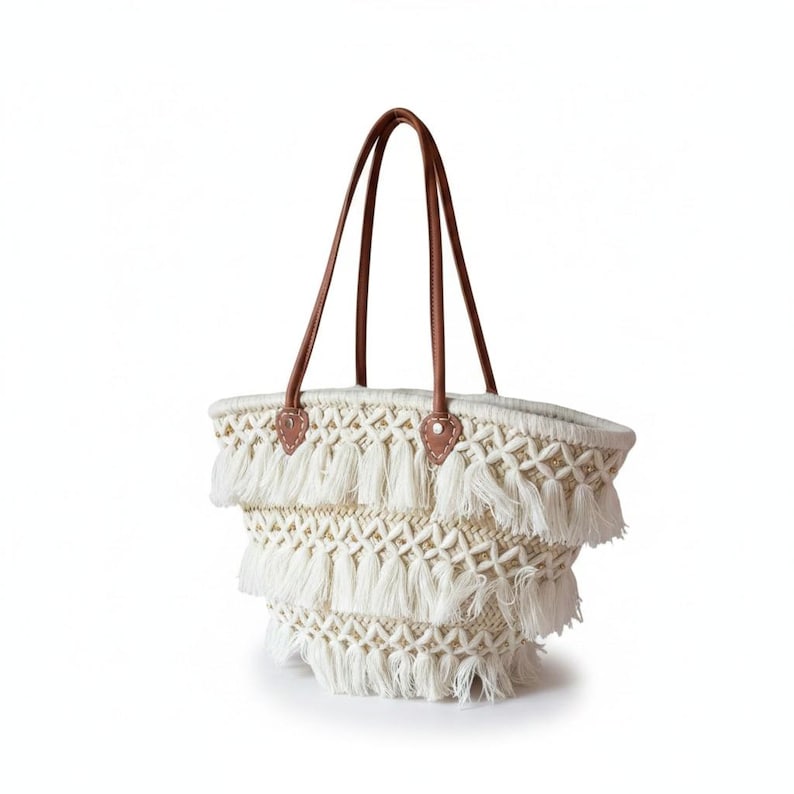 Ivory macramé fringe straw bag with genuine leather handles and silver rivets